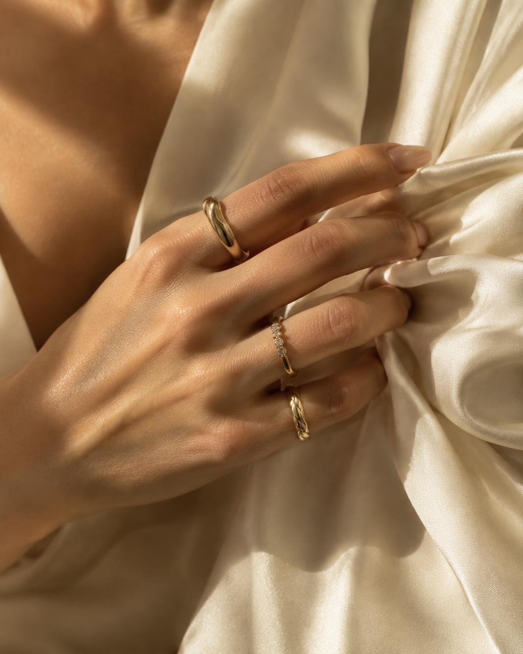Gold rings styled on ivory silk